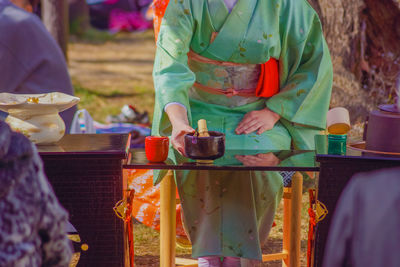 Midsection of woman holding food