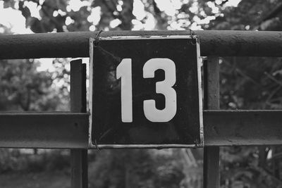 Close-up of number 13 on railing