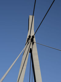 Low angle view of wind turbine against clear blue sky