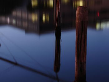 Close-up of wooden poles in water