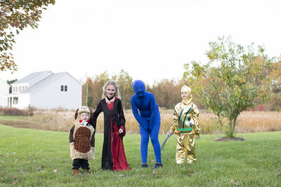 Four siblings ages toddler to tween in halloween costumes