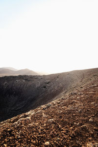 Scenic view of arid landscape against clear sky