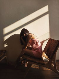 Woman sitting on chair at home