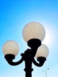 Low angle view of street light against clear blue sky