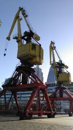 Low angle view of crane against clear sky