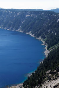 Scenic view of sea and mountains against sky