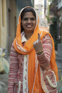 Indian woman showing finger after polling, casting vote, india