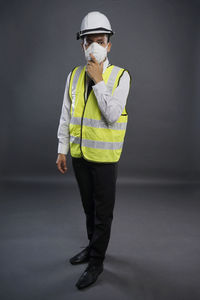 Portrait of man standing against white background