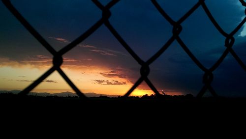 Silhouette of fence at sunset