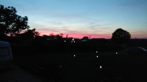 Silhouette trees against sky at sunset