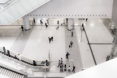 High angle view of people walking on escalator