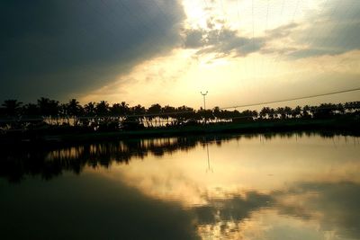 Scenic view of lake against sky at sunset