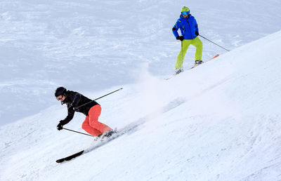 Full length of men skiing on snow