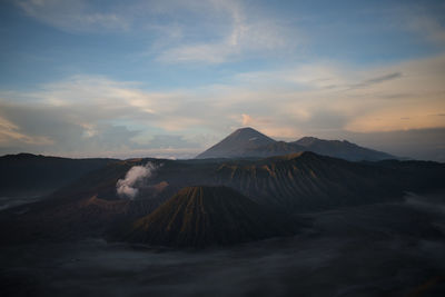 View of volcanic landscape against cloudy sky bromo