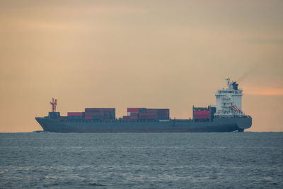 Ship sailing on sea against sky