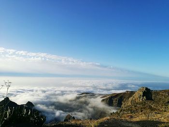 Scenic view of mountains by cloudscape