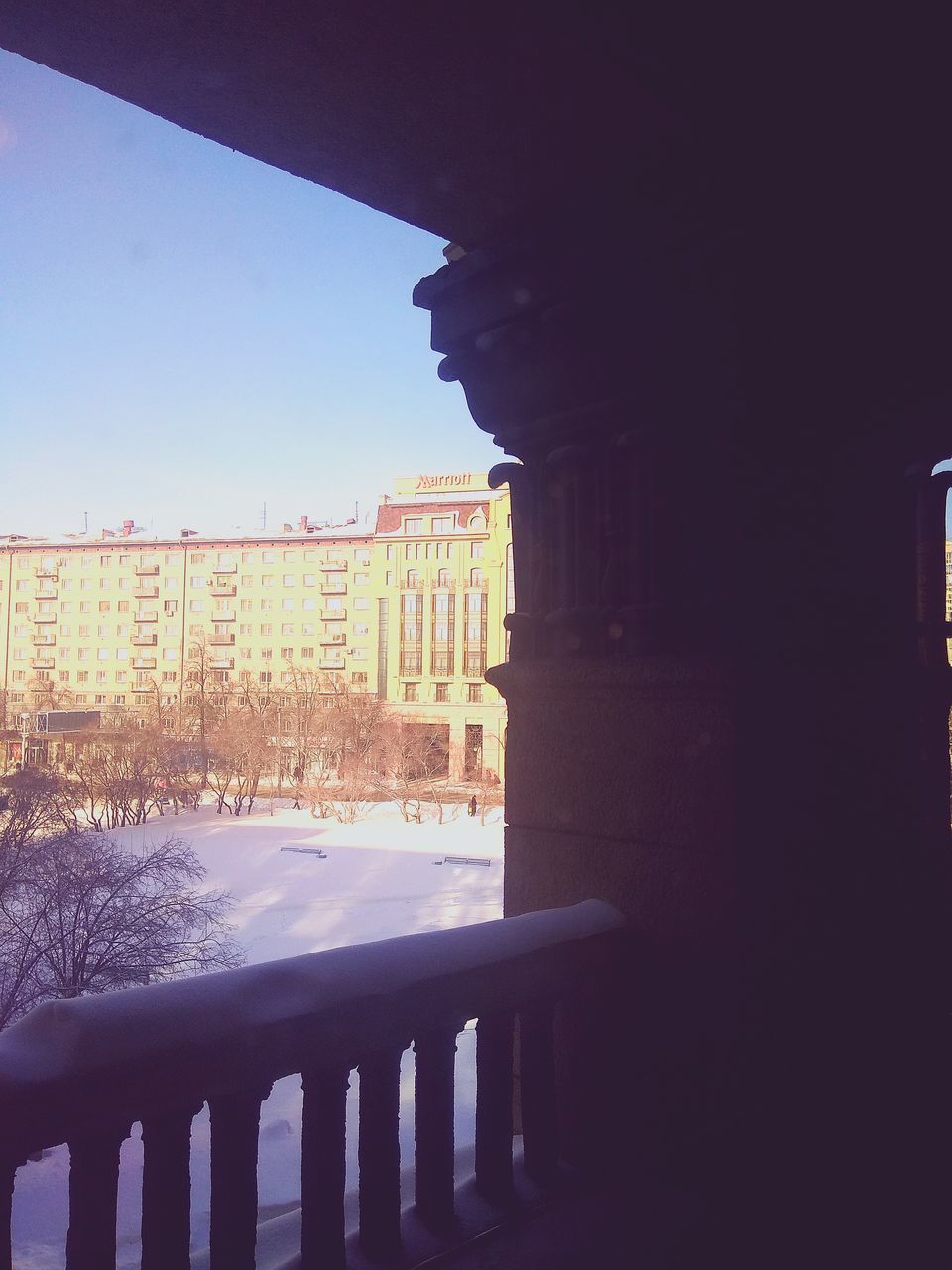 VIEW OF BUILDING SEEN THROUGH RAILING