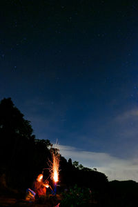 High angle view of illuminated bonfire against sky at night