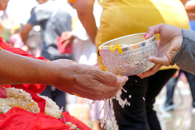 Cropped image of person pouring water on hands