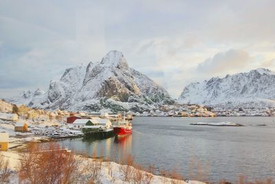 Scenic view of lake and mountains against sky