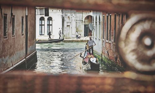 Rear view of man standing in canal