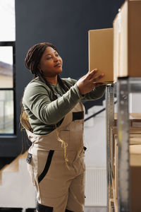 Side view of young woman using mobile phone