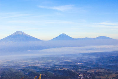 Scenic view of mountains against cloudy sky