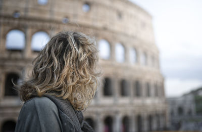 Woman looking at coliseum 