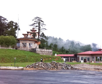 Built structure by road against clear sky