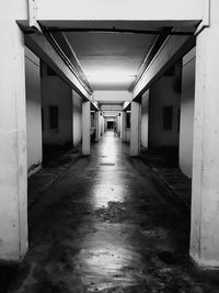 Empty corridor along pillars