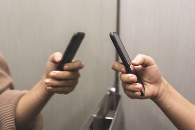 Close-up of hands holding mobile phone