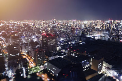 High angle view of illuminated city buildings at night