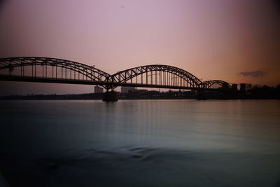 View of bridge over rhein in cologne at sunset