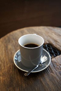 Close up cup of hot black coffee on wooden table