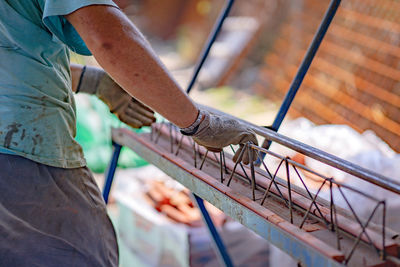 Close-up of man working on metal