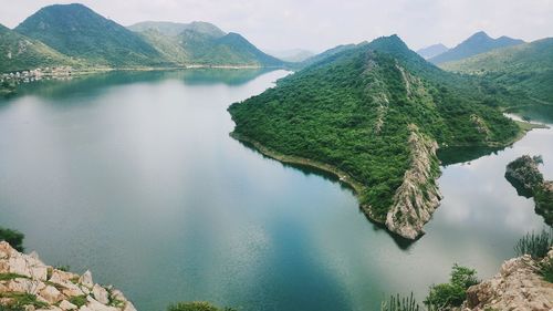 Scenic view of lake and mountains against sky