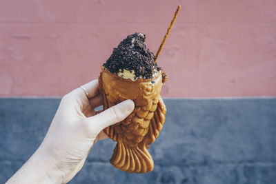 Close-up of hand holding ice cream