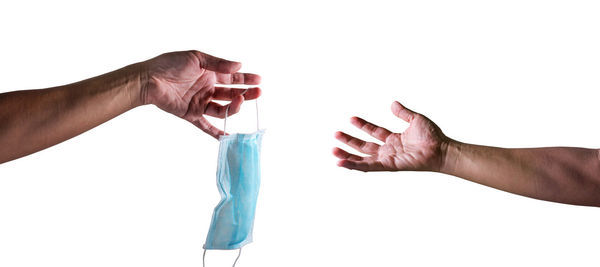 Close-up of person hand against white background