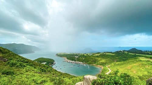 Scenic view of green landscape against sky