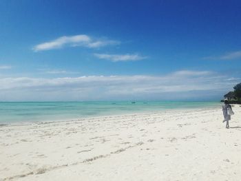 Scenic view of beach against blue sky