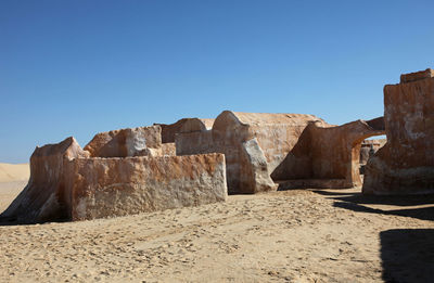 Rock formations against clear blue sky