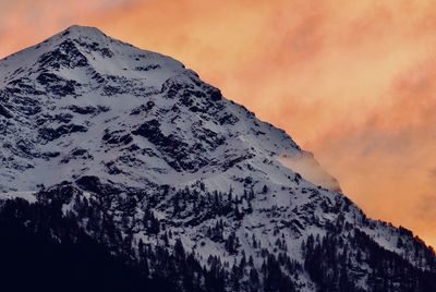 Scenic view of snowcapped mountains against sky during sunset