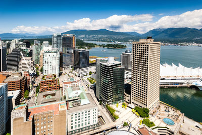 High angle view of buildings by sea against sky