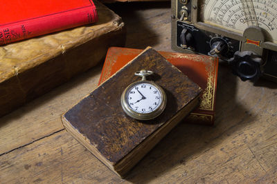 High angle view of clock on table