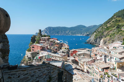 High angle view of buildings by sea against clear sky