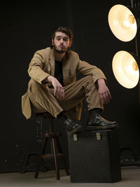 Male model sitting on chair looking foward