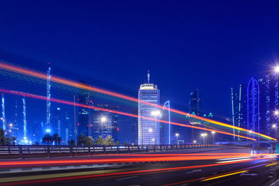 Illuminated bridge over river at night