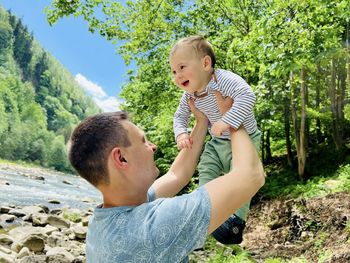 A happy father raises his son above himself. family concept. spending time with children.