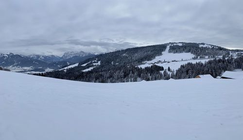 Scenic view of snowcapped mountains against sky