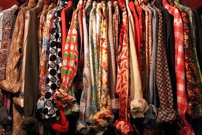 Close-up of clothes hanging in row for sale